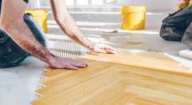 Photo d'un homme en train de poser du parquet