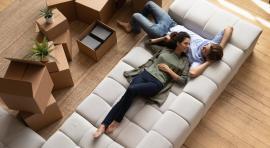 Photo d'un couple homme/femme sur un canapé de leur appartement loué LMNP
