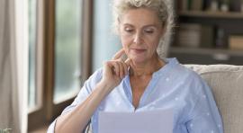 femme-agee-lisant-documents-en-reflechissant-a-retraite-par-capitalisation-vs-par répartition-quel-choix